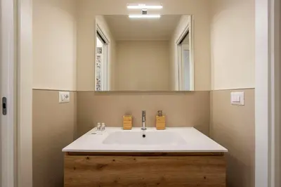 a bathroom with a sink and a mirror at Aurelius Design Loft 2 in Rome