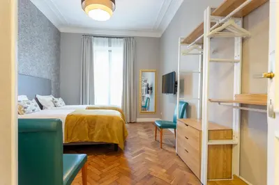 a hotel room with a bed and a television at Elegance and Style near St Peter's in Rome