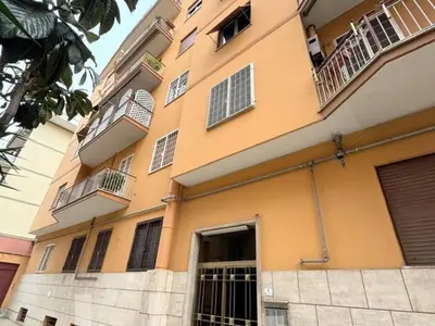 a large orange building with two balconies on it at Hi HOME in Rome