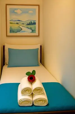 a bed with a towel with a rose on it at Hi HOME in Rome