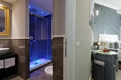 a bathroom with a toilet and a sink and a shower at Sistina Twentythree luxury rooms in Rome