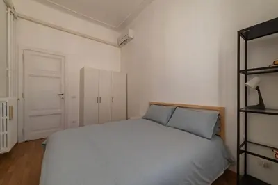 a bedroom with a bed and a desk and a window at GuestHost - Terrace Apartment Nomentano - Roma in Rome