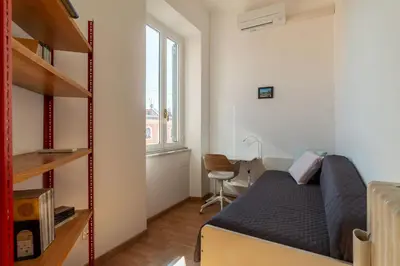 a small kitchen with a table and chairs and a table at GuestHost - Terrace Apartment Nomentano - Roma in Rome