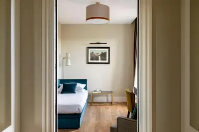 a hotel room with a bed and a table at HOTEL ADRIANO Rooftop in Rome
