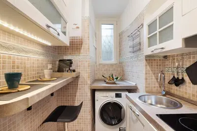 a kitchen with a washing machine and a sink at Appartamento Moderno nel Cuore di Roma in Rome