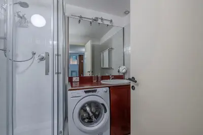 a bathroom with a washing machine and a sink at Vibrant Trastevere 2 bedrooms on Via del Moro in Rome