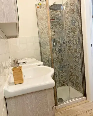 a bathroom with a sink and a shower at Loft with little backyard and patio in Rome