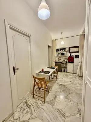 a living room with a marble floor and a table at Edo's Rhome in Rome