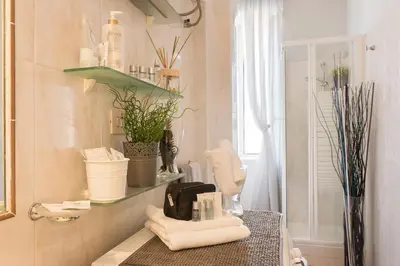 a bathroom with a sink with towels on a counter at Aly Apartment in Vatican in Rome