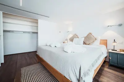a bedroom with a large bed with white sheets at Skylife 360 Rooftop Penthouse in Rome