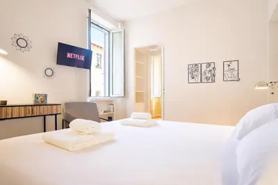a bedroom with a large white bed with towels on it at Elegantis Monti Royal Apartment with private terrace in Rome