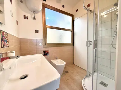 a bathroom with a sink and a toilet and a window at Bauhouse in Rome