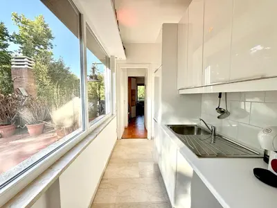 a kitchen with a sink and a large window at Bauhouse in Rome