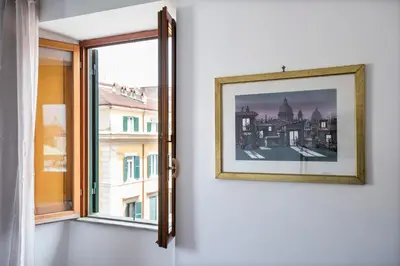 a picture hanging on a wall next to a window at Paramount Penthouse in Rome