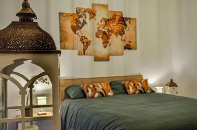 a bedroom with a bed with paintings on the wall at Moletta 17 in Rome