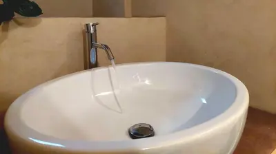 a white sink with a faucet in a bathroom at Pantheon in finestra in Rome