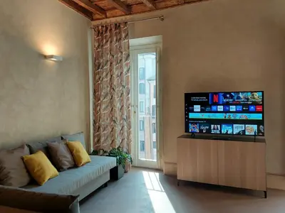 a living room with a couch and a flat screen tv at Pantheon in finestra in Rome
