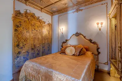 a bedroom with a bed in a room with blue walls at Villino Ermes Campanelli in Rome
