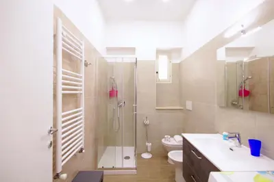 a bathroom with a shower and a toilet and a sink at HC - Piazza Vittorio Emanuele Dream in Rome