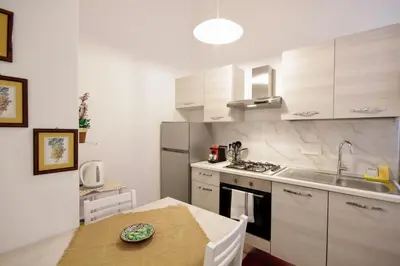 a small kitchen with a table and a sink at HC - Piazza Vittorio Emanuele Dream in Rome