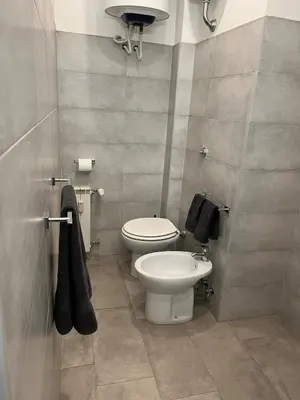 a bathroom with a toilet and a sink at Cozy Donatello Apartment in Rome