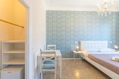 a bedroom with a bed and a table and a desk at B&B Floret Roma San Giovanni in Rome