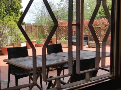 a wooden table and chairs on a patio at La Terrazza del Poeta in Rome