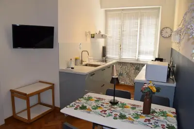 a small kitchen with a sink and a table with a table sidx sidx at Casa Luminosa in Monteverde in Rome