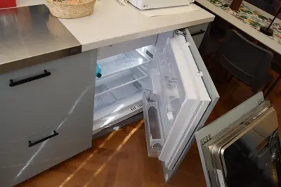 an open refrigerator with its door open in a kitchen at Casa Luminosa in Monteverde in Rome