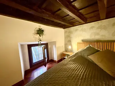 a living room with a table and a chair at Trastevere Loft garden in Rome
