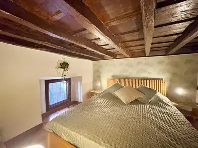 a bedroom with a large bed in a room at Trastevere Loft garden in Rome