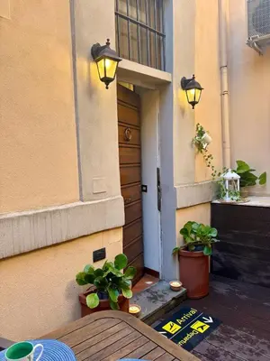 a wooden table with two potted plants on a patio at Trastevere Loft garden in Rome