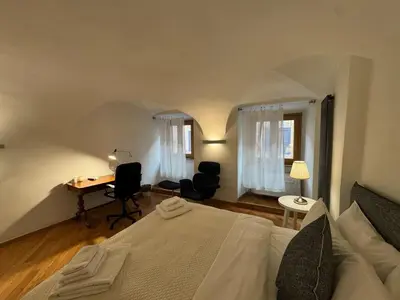 a bedroom with a bed and a desk in a room at New! Renovated Apt in Ancient Rome in Rome