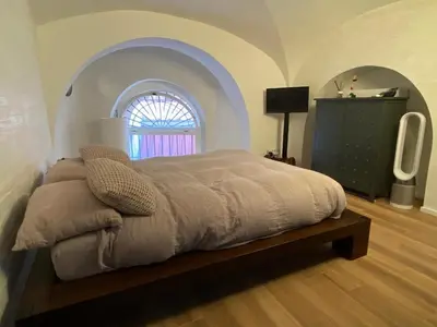 a bedroom with a bed in a room with a window at loft Trastevere in Rome
