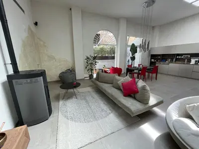 a living room with a couch and a tv in it at loft Trastevere in Rome