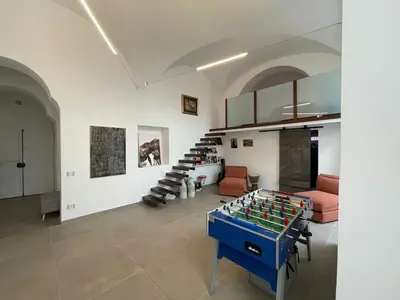 a living room with a foosball table in the middle at loft Trastevere in Rome