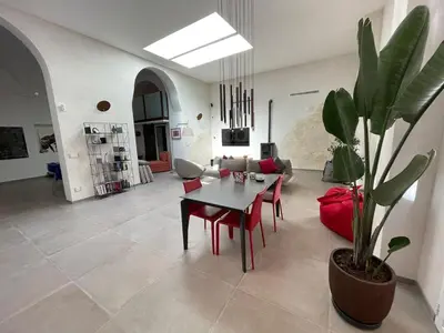 a living room with a table and a potted plant at loft Trastevere in Rome