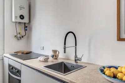 a kitchen with a sink and a bowl of fruit at Amazing Piramide Metro Station in Rome