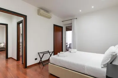a bedroom with a large bed and a mirror at Nōma Pigneto by Hostand in Rome