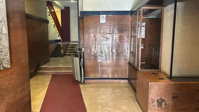 a hallway with a metal refrigerator in a building at Nōma Pigneto by Hostand in Rome