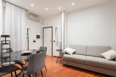 a living room with a couch and a table at Nōma Pigneto by Hostand in Rome