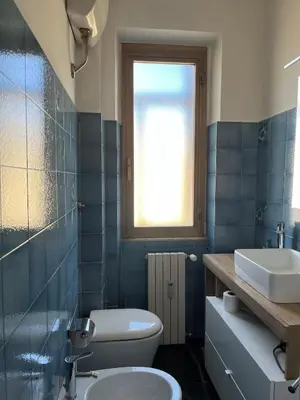 a bedroom with a bed with two orange pillows at Casa del Grillo in Rome