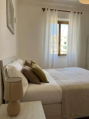 a bedroom with a bed with pillows and a window at Casa del Grillo in Rome