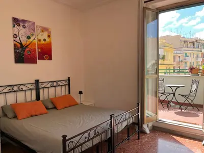 a white bedroom with a bed and a window at Casa del Grillo in Rome