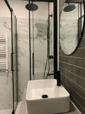 a white sink in a bathroom with a shower at RipettArt Apt in Rome