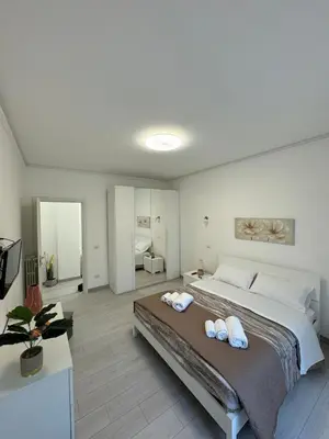 a bedroom with a large bed with two towels on it at holiday home modern 2 rooms near colosseo in Rome
