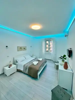 a bedroom with a large bed in a blue room at holiday home modern 2 rooms near colosseo in Rome
