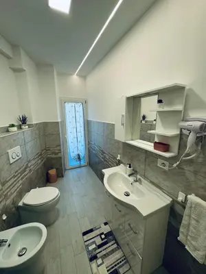 a bathroom with a sink and a toilet and a mirror at holiday home modern 2 rooms near colosseo in Rome