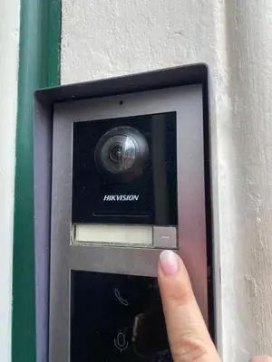 a hand is holding a button on a mail box at Casa per Ferie Suore Salesiane dei Sacri Cuori in Rome