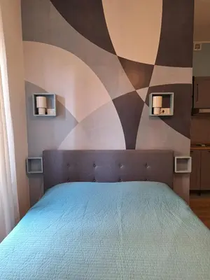 a bedroom with a bed with a painting on the wall at Casa Laila in Rome